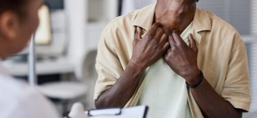 a man shows his neck skin to a doctor