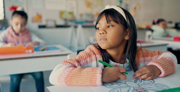 Child sitting at desk at school