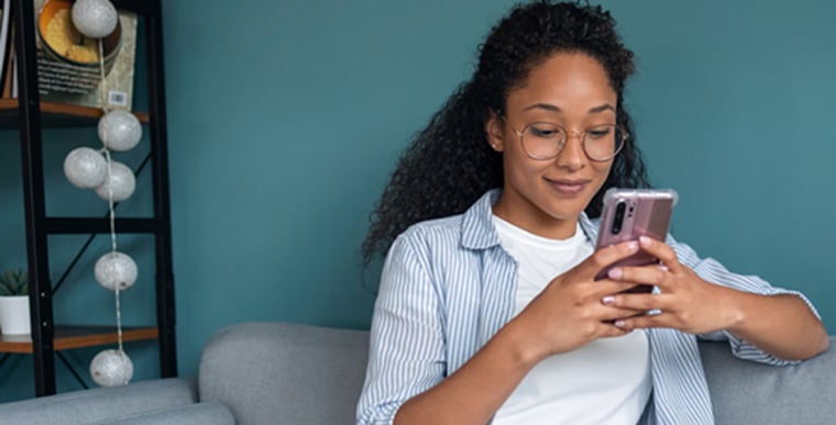 Woman typing on mobile phone