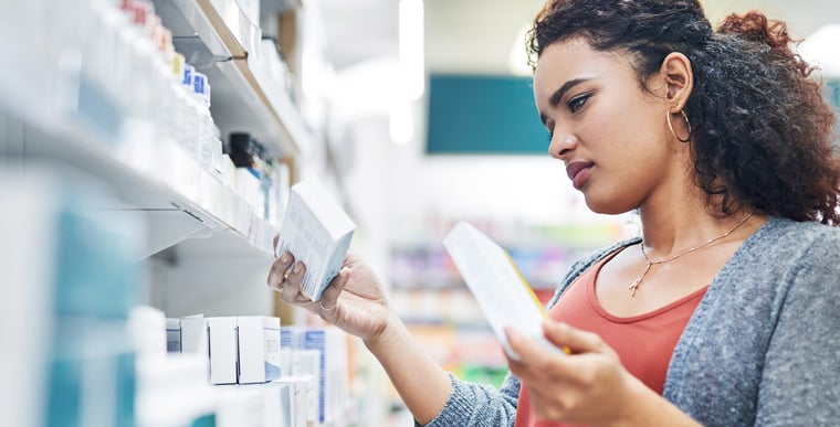 Woman browsing through eczema cream medications in store
