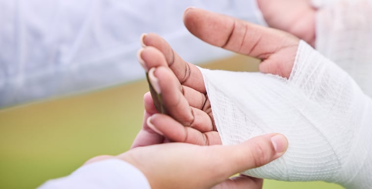 Hand wrapped in cloth for wet wrap therapy