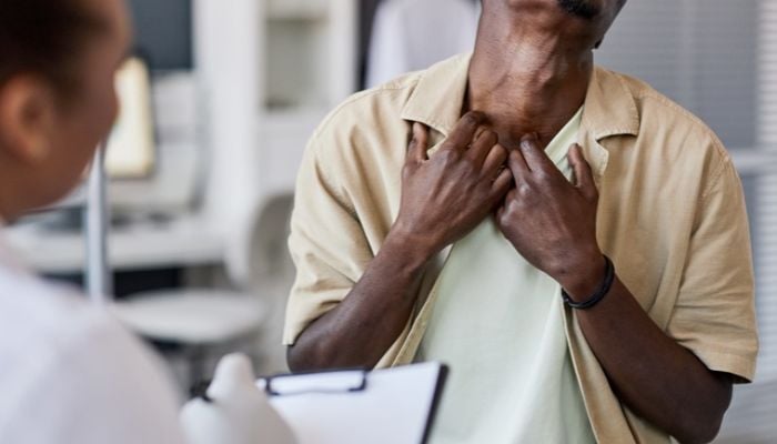 a man shows his neck skin to a doctor