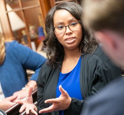 Woman speaking to group of people around her