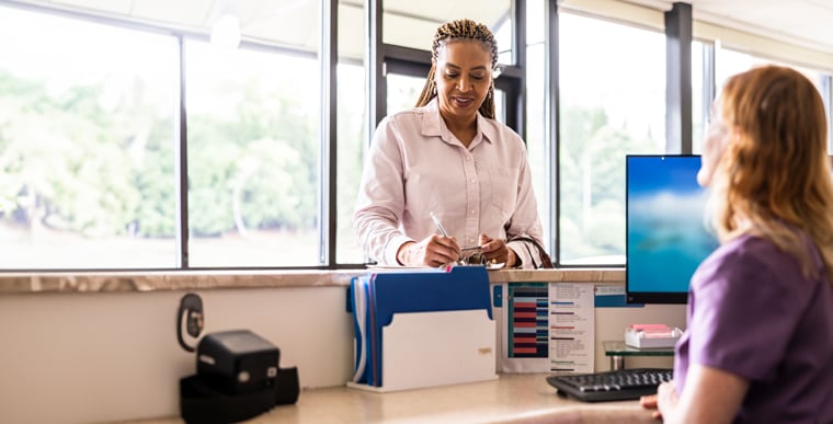 Patient signing in at front desk