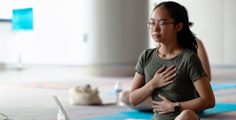 Woman holding hand over chest