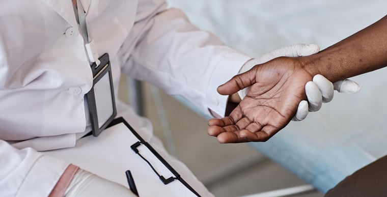 Doctor holding patient's arm