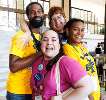 Group posing for photo smiling