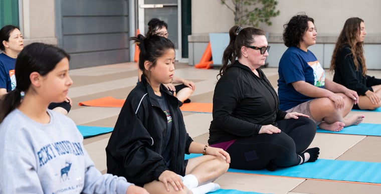 Image of group sitting doing yoga as a supplementary treatment for eczema