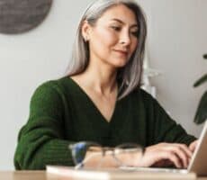 a woman works on her computer