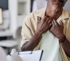 a man shows his neck skin to a doctor