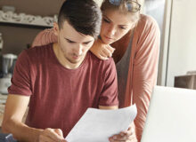 Man and woman look at sheets of paper