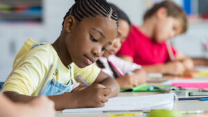 Black child writing in class