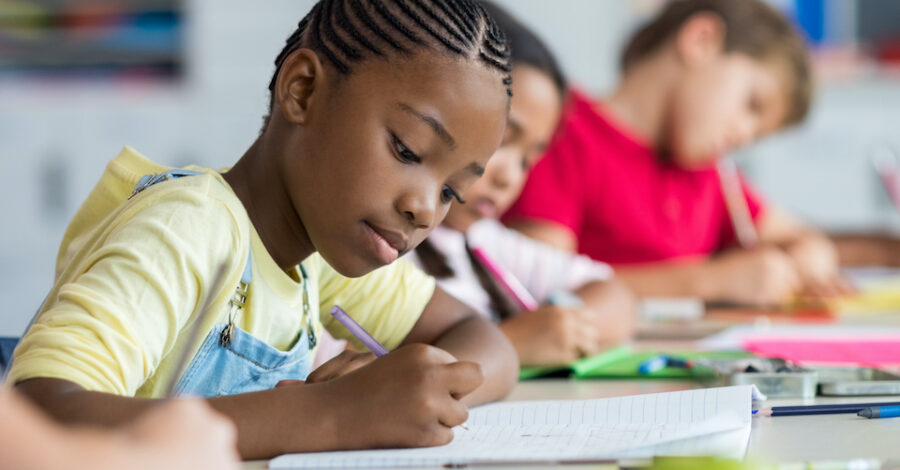Black child writing in class