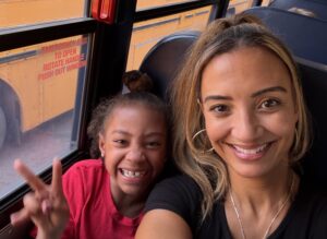 A mother and daughter riding a school bus.