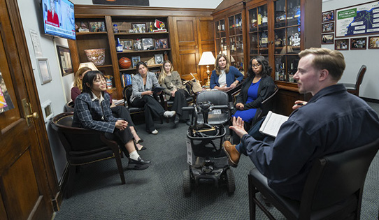 NEA Ambassadors, staff and board members gathered in a circle inside a representative’s office during a meeting